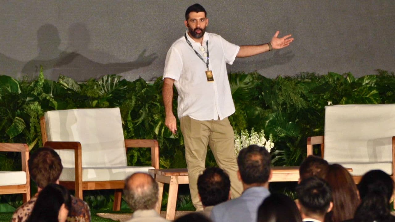 Farzad Mesbahi on stage at the SovAI Summit, El Salvador